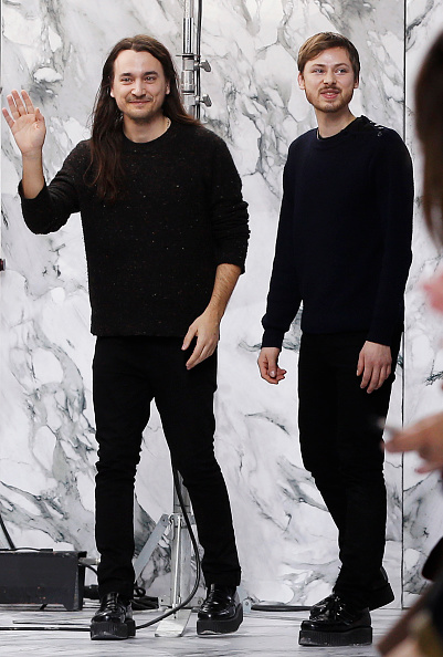 Designers Alexis Martial and Adrien Caillaudaud acknowledge the audience following the Carven 2016-2017 fall/winter ready-to-wear collection fashion show on March 3, 2016 in Paris. AFP PHOTO / FRANCOIS GUILLOT / AFP / François GUILLOT (Photo credit should read FRANCOIS GUILLOT/AFP/Getty Images)